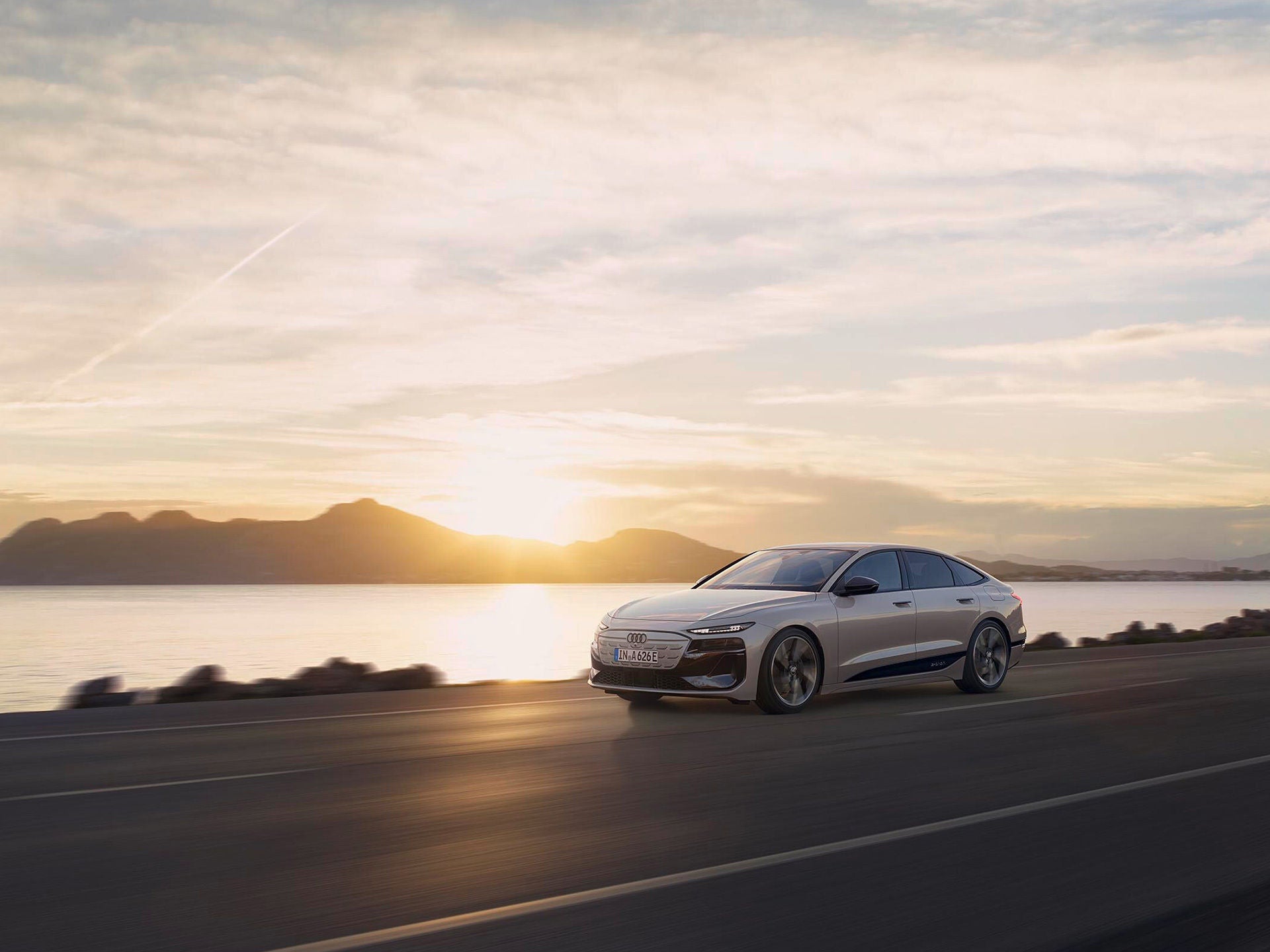 Audi A6 Sportback e-tron performance drives in front of a sunset